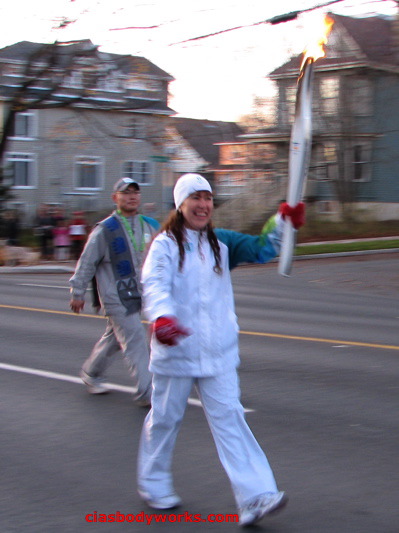 Olympic Torchbearer Cia Tweel carries the Flame