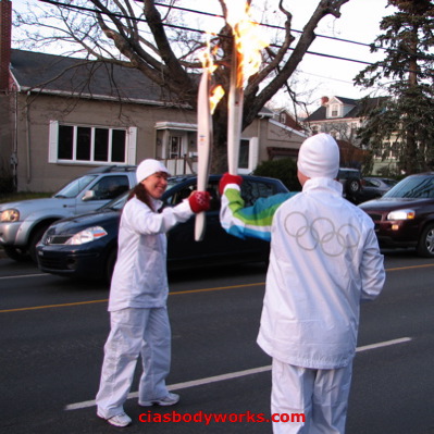 Olympic Torchbearer Cia Tweel receives the Flame